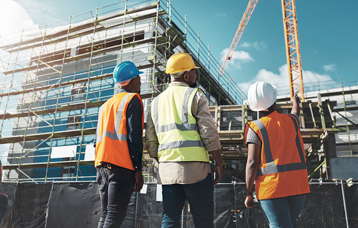 group of builders assessing progress at a construction site